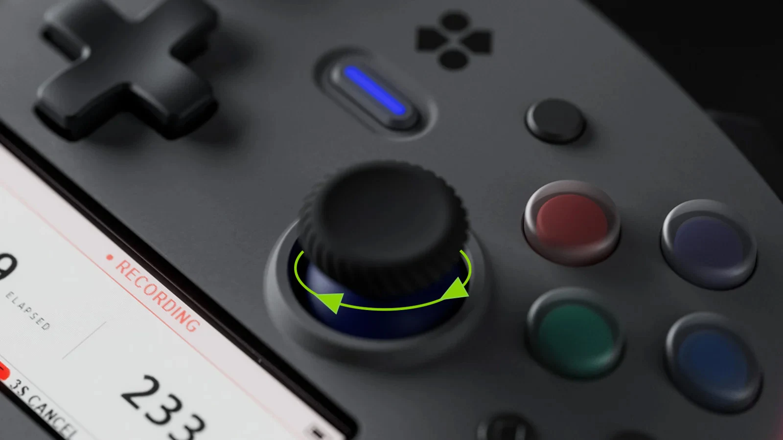 Close view of a Genki Manta joystick with green arrows showing it twisting left and right